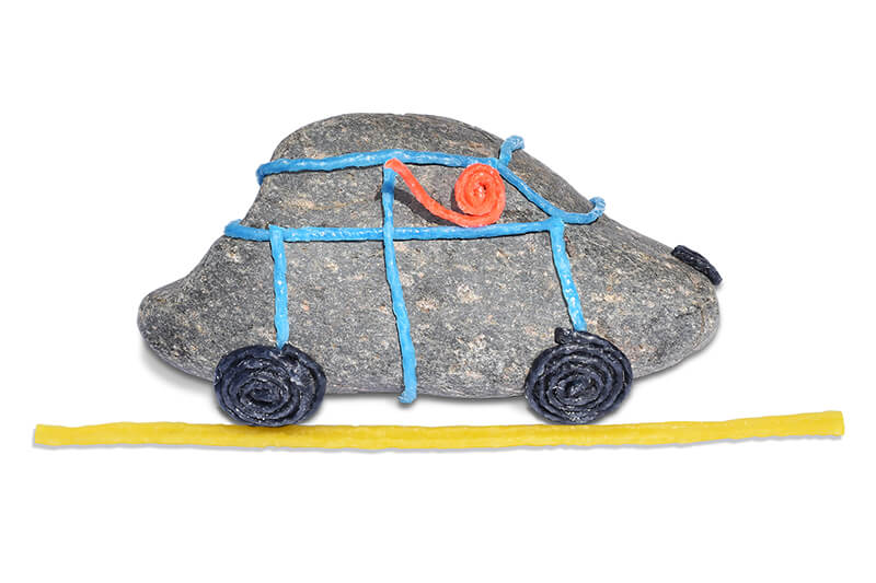 Rock decorated to look like a car with Wikki driver.