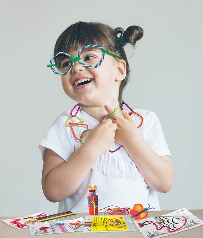 Girl in Wikki glasses and necklace.