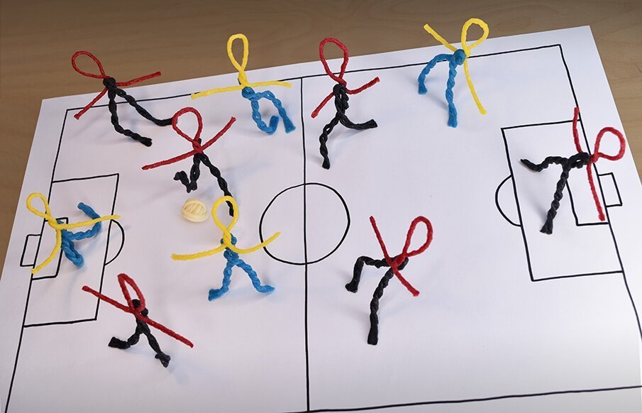 Ten Wikki soccer players in Wikki uniforms.