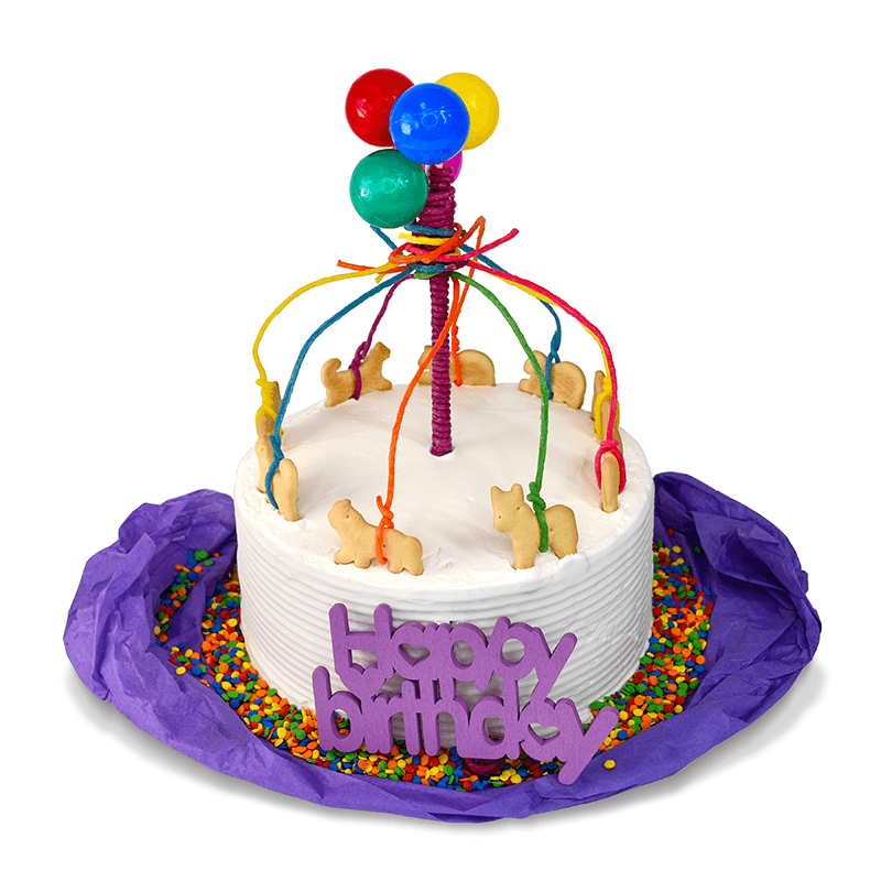 Beautiful carousel cake using animal crackers and Wikki Stix to decorate the top.