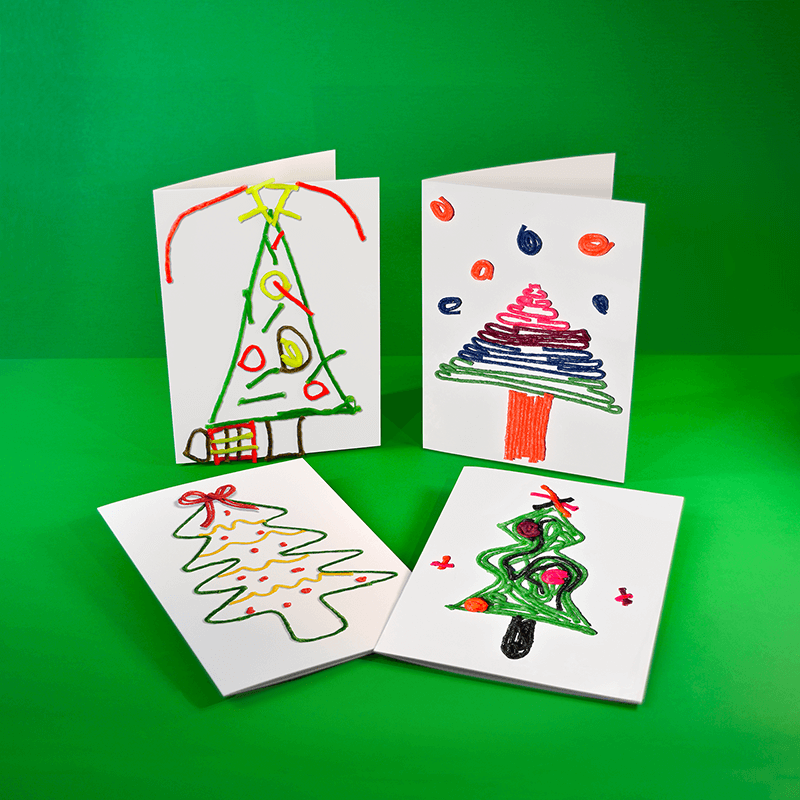 Four Christmas Tree cards created with Wikki Stix by 2nd grade students.